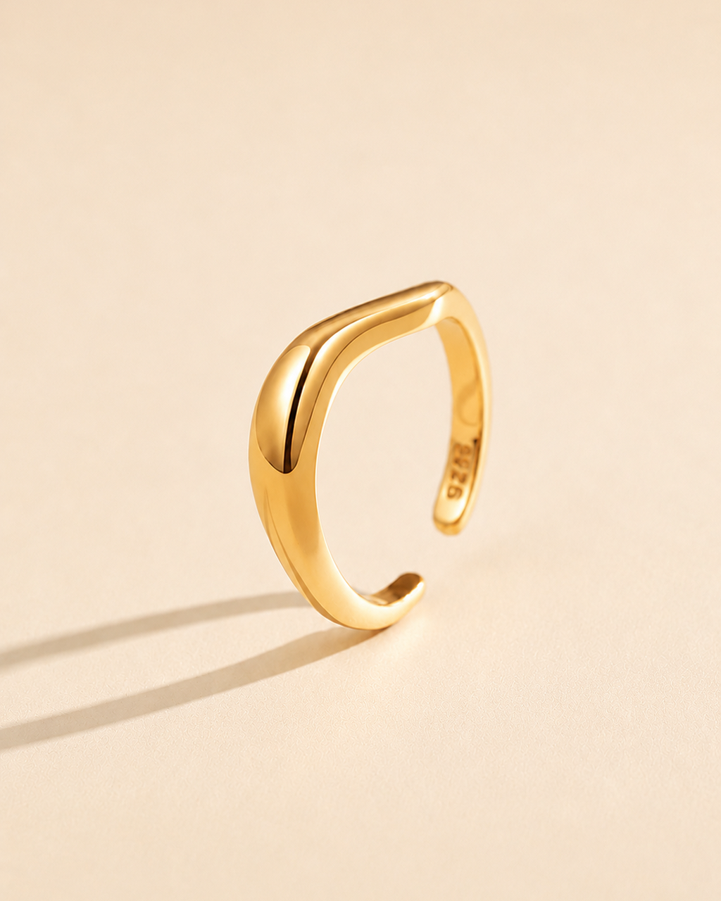 Sculpt Wave adjustable ring in S925 sterling silver with thick 18K gold plating, featuring a polished sculptural curved design on a soft beige background.