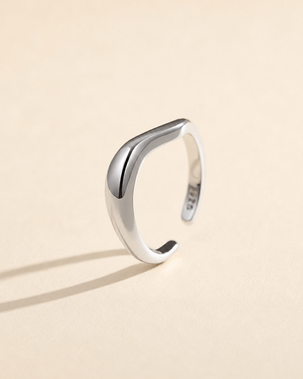 Sculpt Wave adjustable ring in S925 sterling silver with thick 18K white gold plating, featuring a polished organic curved design on a soft beige background.