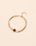Tiger Eye herringbone bracelet crafted from thick 18K gold plated S925 sterling silver on a soft cream background.