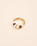 Tiger Eye and Mother of Pearl beaded ring in thick 18K gold plated S925 sterling silver on a soft cream background.