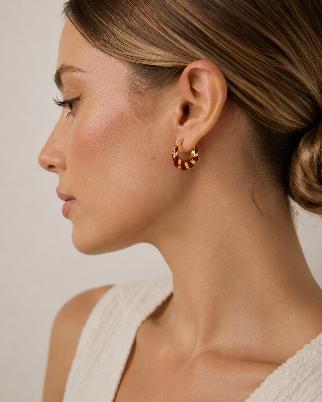 Model wearing red enamel hoop earrings in S925 sterling silver with thick 18K gold plating, shown in an elegant side profile.