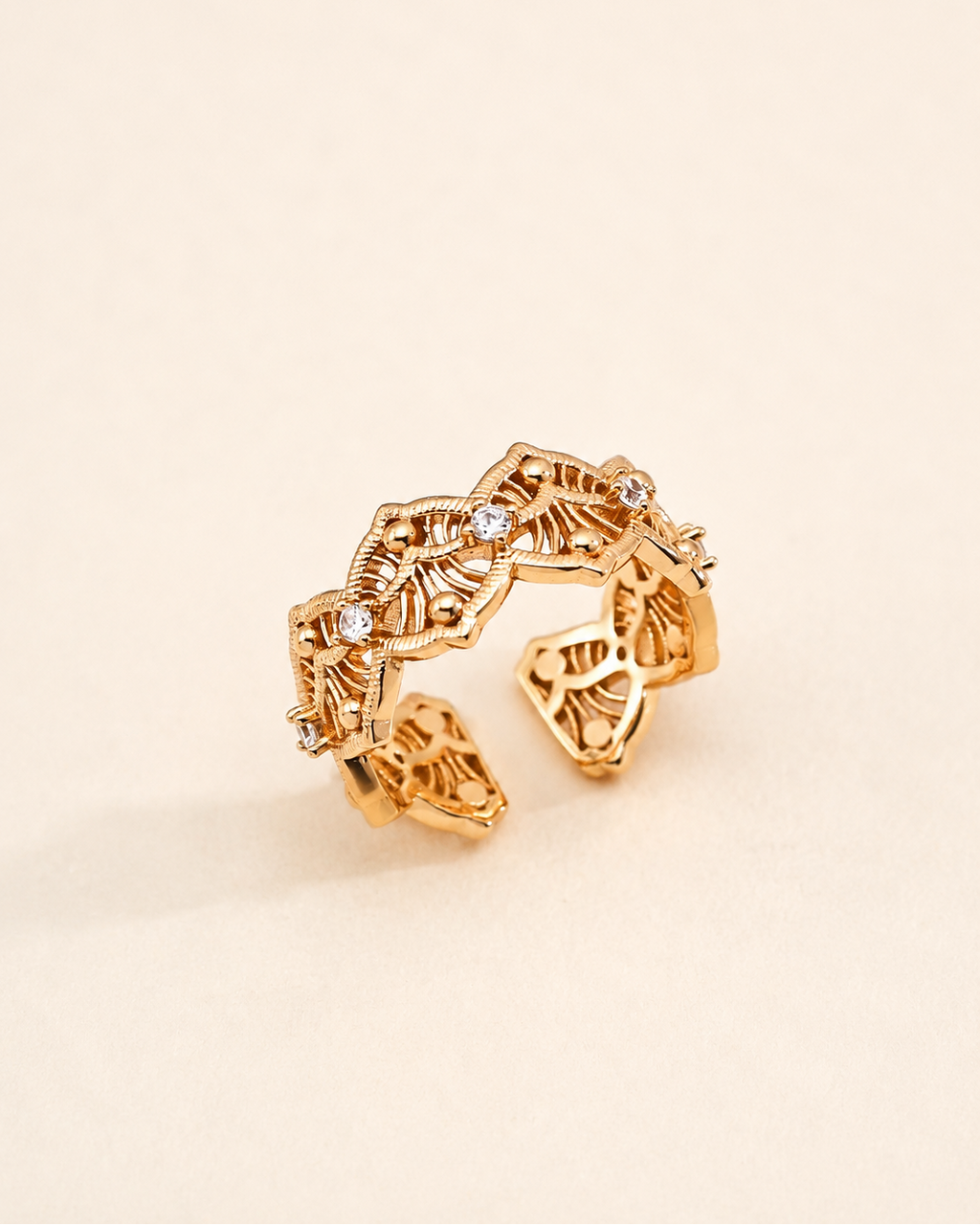 Vintage Lace adjustable ring in S925 sterling silver with thick 18K gold plating and cubic zirconia, featuring an intricate filigree openwork design on a soft beige background.