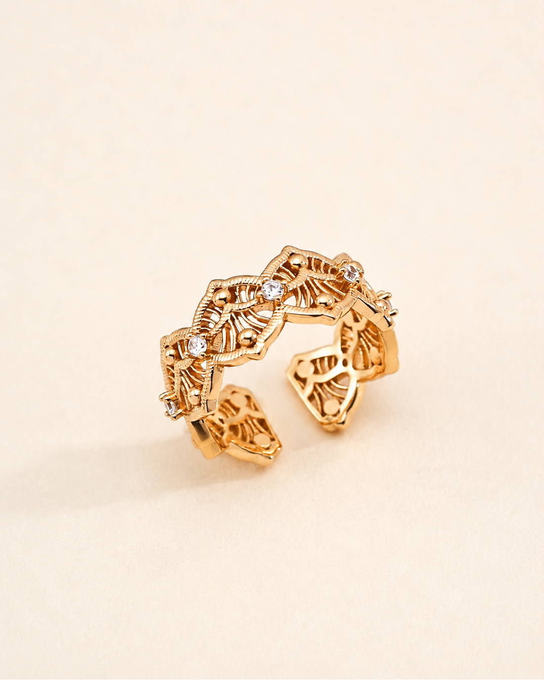 Vintage Lace adjustable ring in S925 sterling silver with thick 18K gold plating and cubic zirconia, featuring an intricate filigree openwork design on a soft beige background.